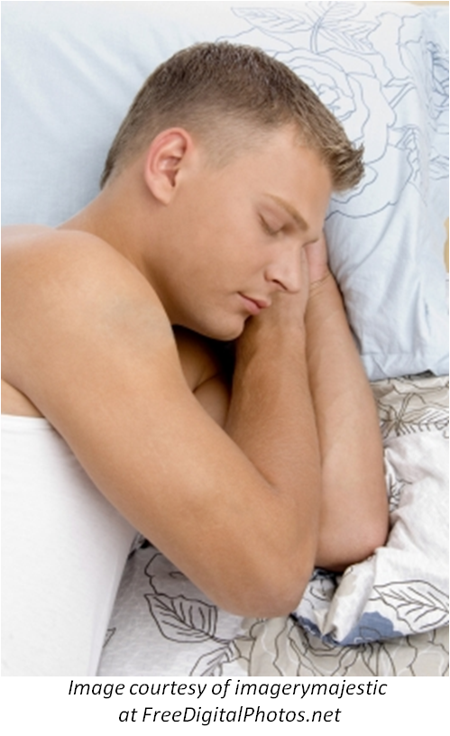 A man fast asleep in bed