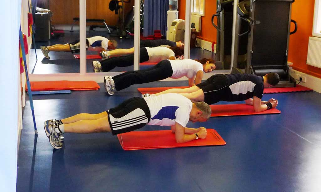 People doing planks in the HIIT class