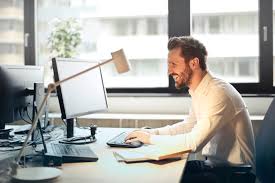 A person happily working at a laptop