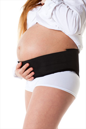 Pregnant woman wearing pelvic support belt